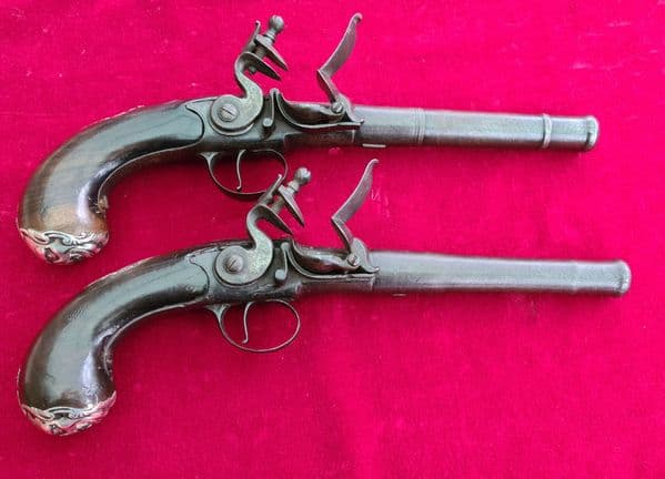 A fine pair of  Queen Anne cannon barrelled silver mounted flintlock pistols. Circa 1760. Ref 3732.