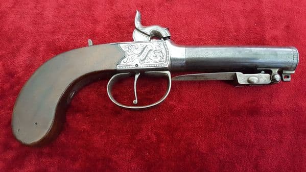 A good English single barrelled percusion pistol with spring bayonet by 
