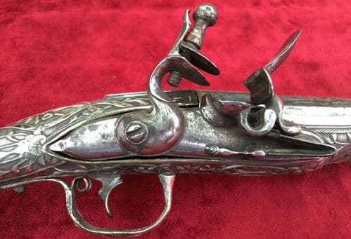 A GREEK Flintlock Pistol. Covered overall with Nielloed silver decoration. Good condition. Ref 7621.
