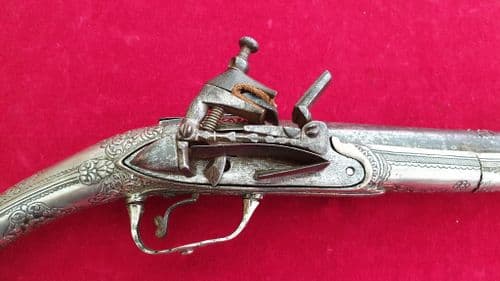 A rare Greek Miquelet  pistol with a solid silver covered stock. Good condition. Ref 2562