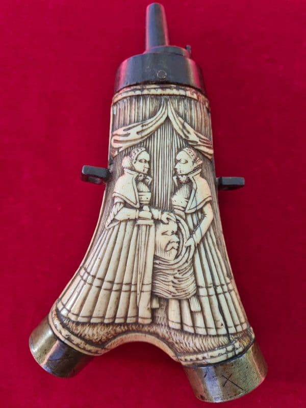 A Superb German 17thC carved stag horn powder flask portraying a beheaded Holofernes.  Ref 3080
