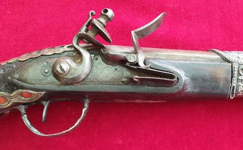 A very attractive 19th century Flintlock holster pistol inlaid with silver and Coral. Ref 2731.