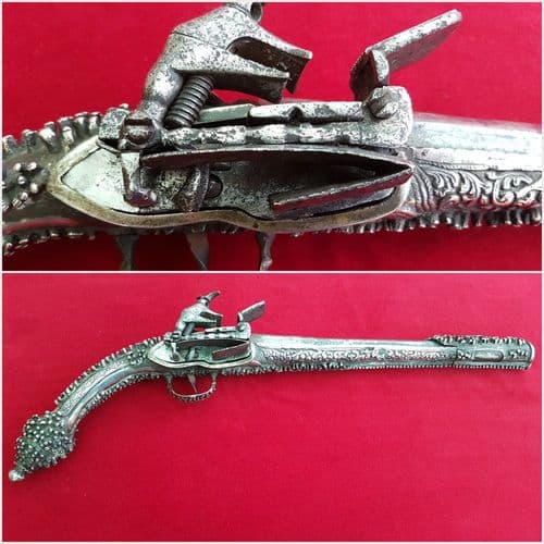 A very long Balkan or Greek Miquelet Flintlock pistol. Elaborate silver decoration. Rat-tail shaped butt. Early 19th century. Ref 8989.