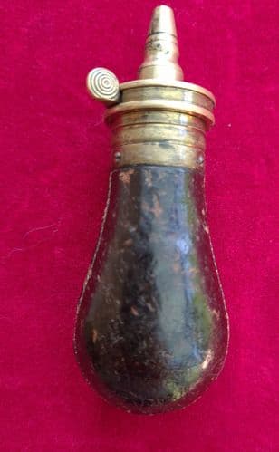 A very tiny black leather covered antique powder flask of unusual small size. 3 inches.  Ref 1341