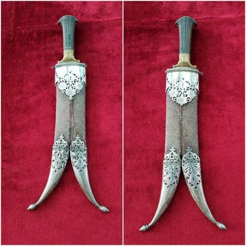 A very unusual Indian Khanjar dagger with horn grip and bi-furcated blade. Complete in its original silver mounted scabbard. Good condition. Ref 9827.