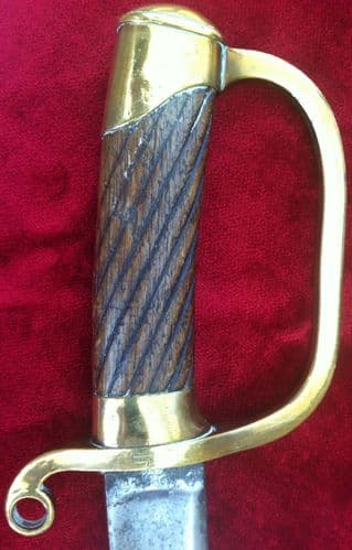 XXX SOLD XXX A rare Russian Cossack sword. Brass handguard, ribbed wooden grips. Ref 6381